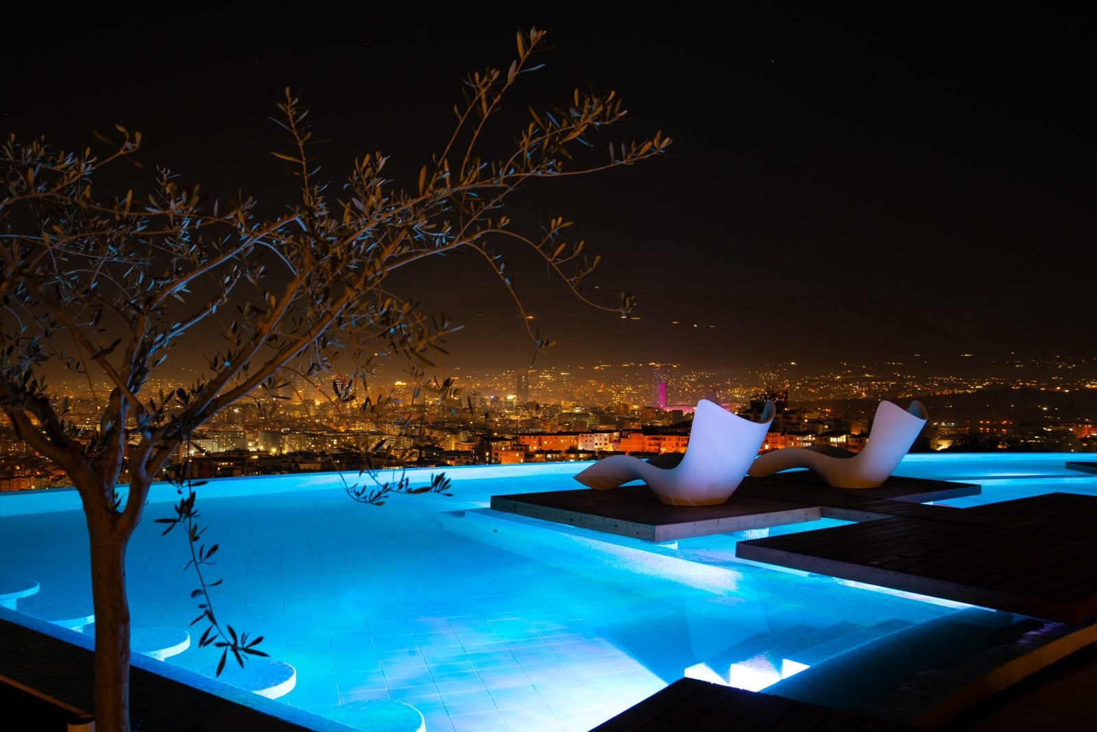 Rooftop infinity pool lit at night over Tirana, Arka Rooftop